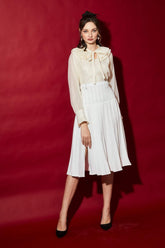 High-waisted silk midi skirt with A-line silhouette and soft pleated drape